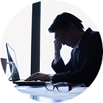 Lawyer in professional setting, focused on work, glasses on desk.